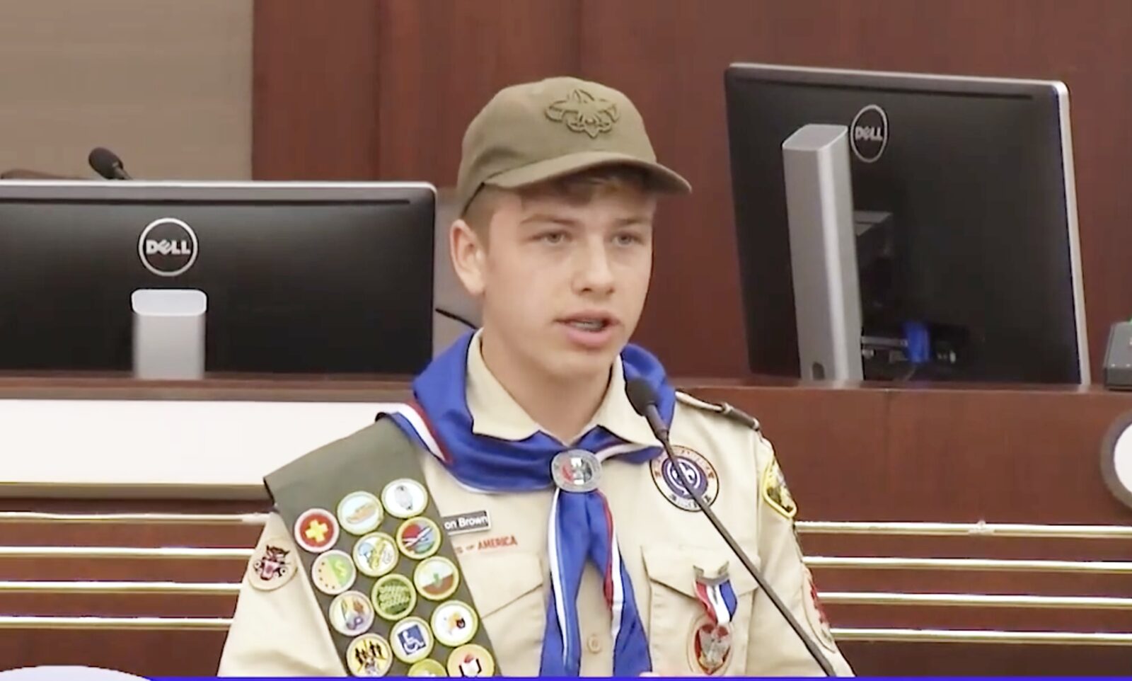 Preston Brown in Scout uniform speaking at a city council meeting
